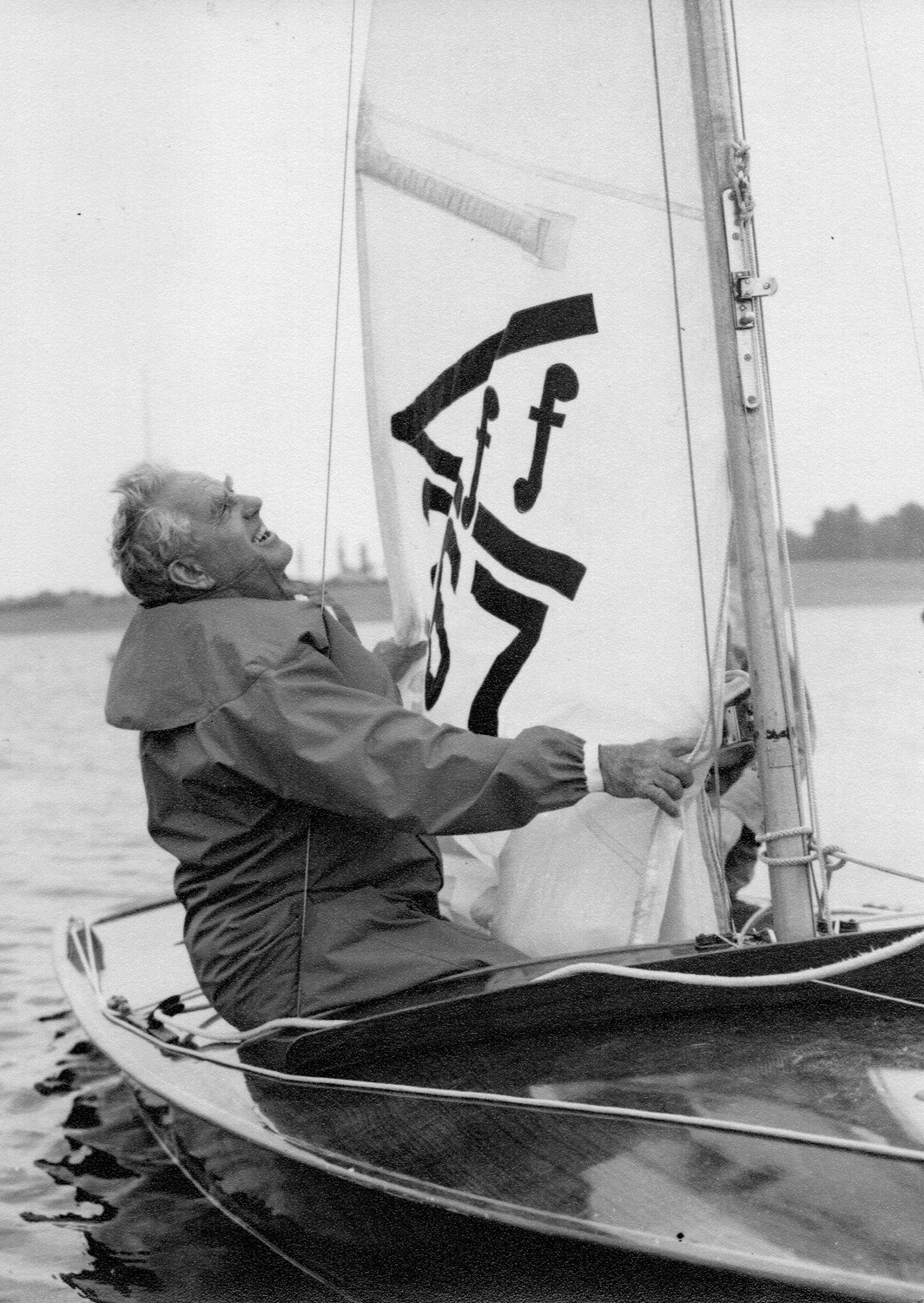 Uffa hoisting the Flying Fifteen mainsail