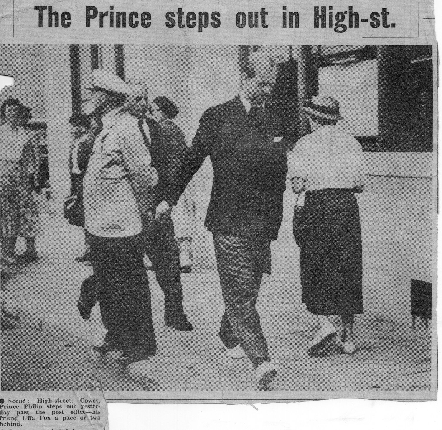 Prince Philip walking through Cowes, with Uffa Fox a pace behind (press cutting)